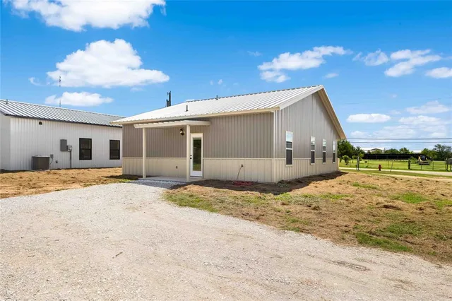 a view of a house with a backyard and garage