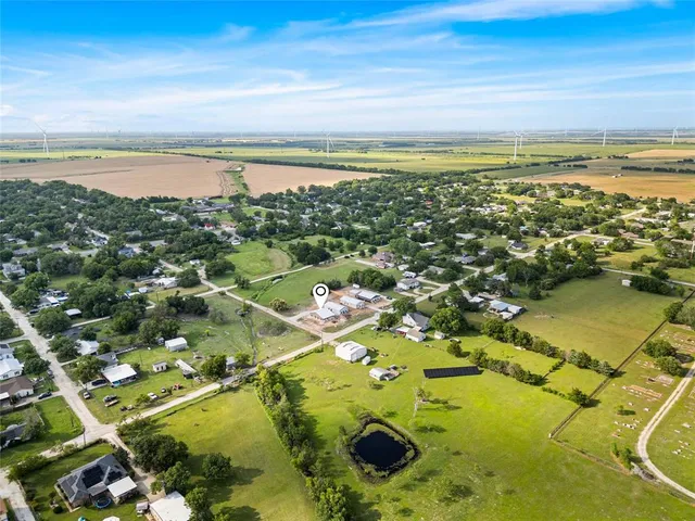 an aerial view of a house with a yard