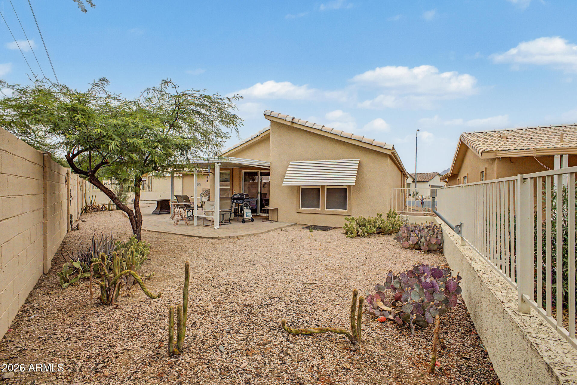 2101 South Meridian Road, Unit 45 Apache Junction, AZ 85120 - Photo 24 of 36 a view of a yard with a house in the background