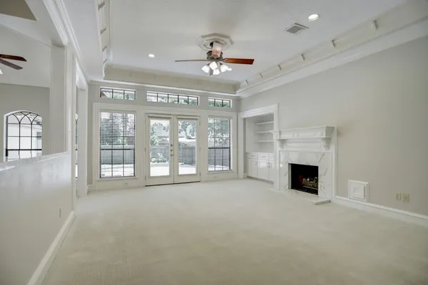 a view of an empty room with a fireplace and a window