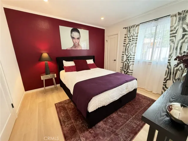 a bedroom with a bed and a potted plant