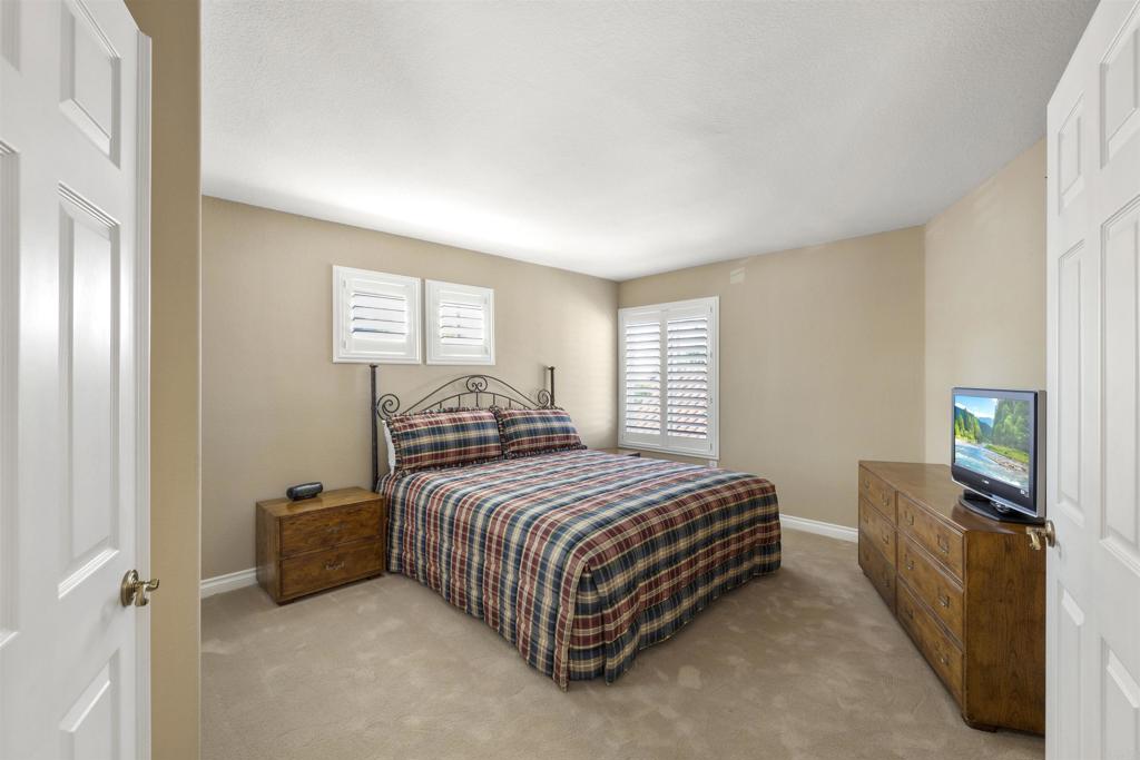 4926 Tilos Way Oceanside, CA 92056 - Photo 36 of 63 a bedroom with a bed and a flat tv screen