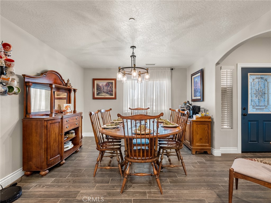 15620 Erie Road Apple Valley, CA 92307 - Photo 7 of 53 a view of a dining room with furniture window and wooden floor