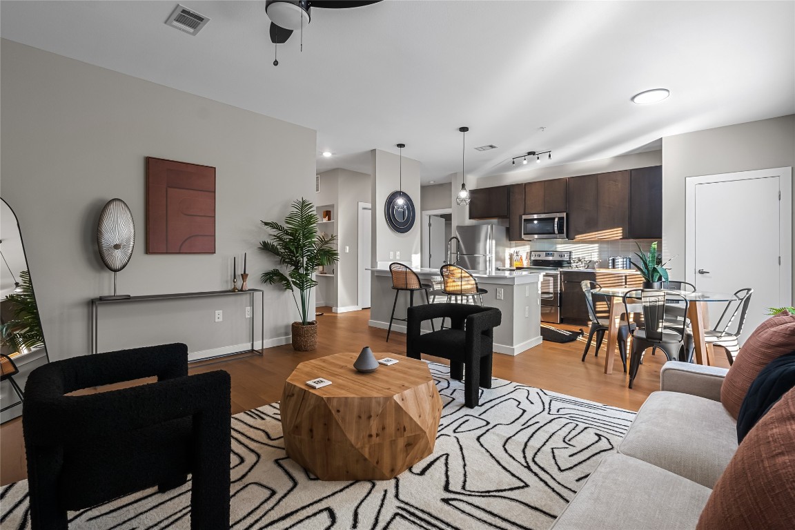 2505 Thornton Road, Unit 2312 Austin, TX 78704 - Photo 1 of 1 a living room with furniture a kitchen view and a fireplace