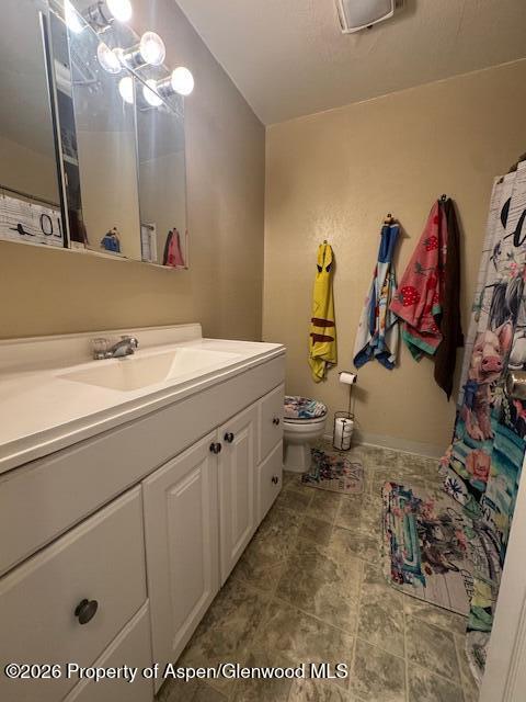 1018 East 7th Street Craig, CO 81625 - Photo 6 of 10 a bathroom with a sink vanity and mirror