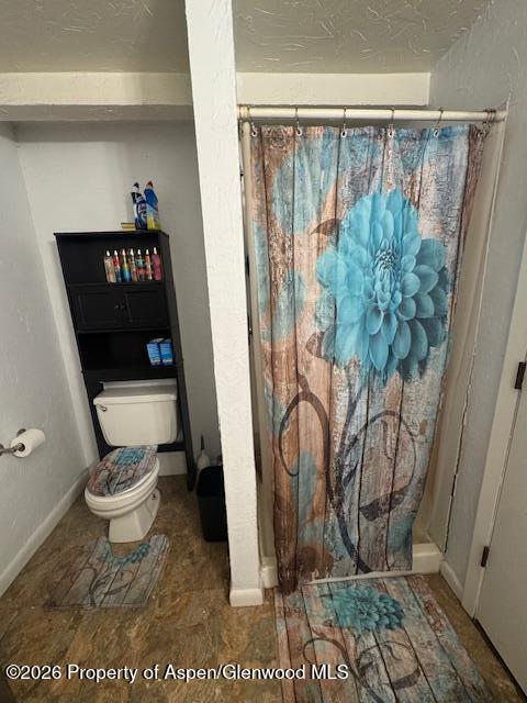 1018 East 7th Street Craig, CO 81625 - Photo 8 of 10 a bathroom with a toilet and a shower