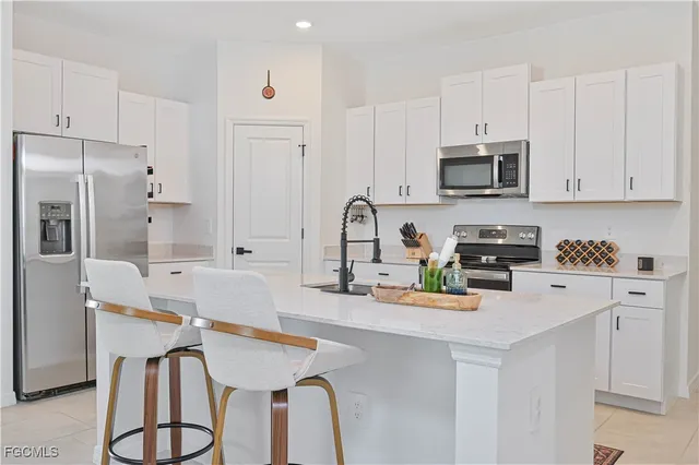a kitchen with a sink cabinets and stainless steel appliances