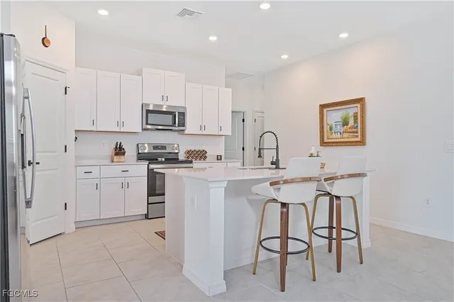 a kitchen with stainless steel appliances a stove microwave and sink