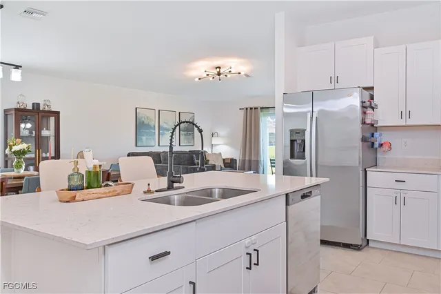 a kitchen with stainless steel appliances granite countertop a sink stove and cabinets