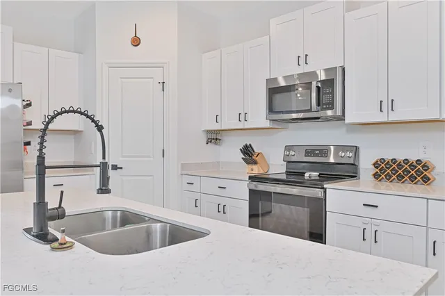 a bedroom with a bed and white cabinets