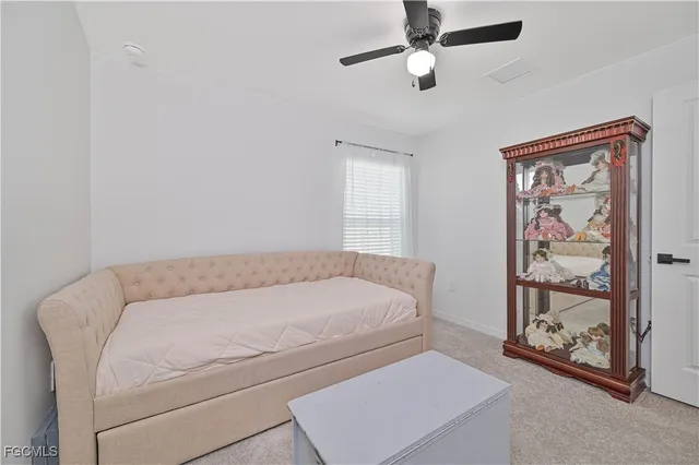 a spacious bedroom with a bed and a chandelier