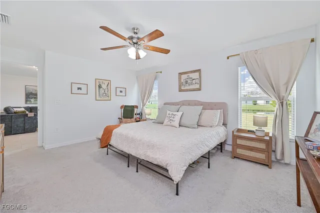 a living room with furniture and a ceiling fan