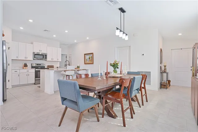 a view of a dining room with furniture and chandelier