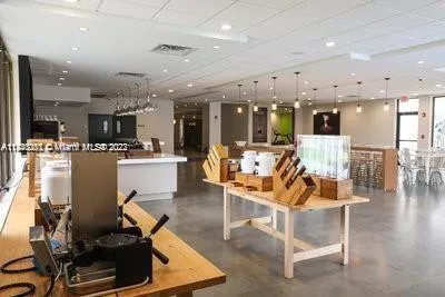 a room with stainless steel appliances lots of furniture and kitchen view