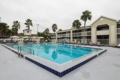 an aerial view of a house with a swimming pool and sitting space