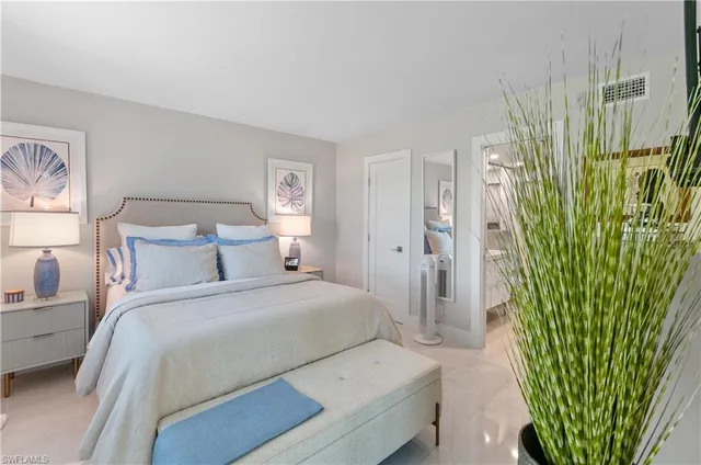 a bedroom with a bed and a plant