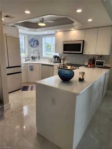 a kitchen with a sink a stove cabinets and refrigerator