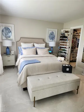 a bedroom with a bed and lamp