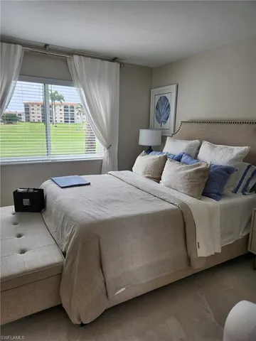 a bedroom with a bed and window