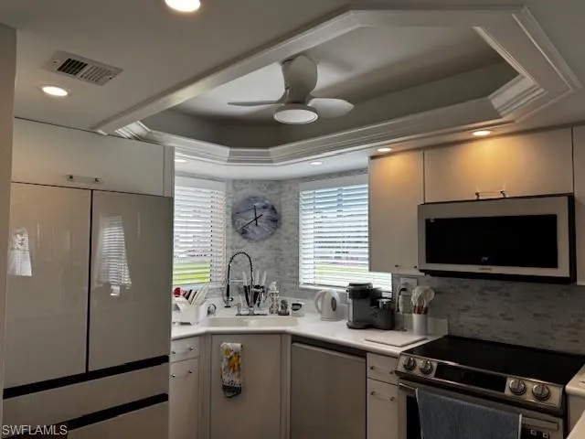 a kitchen with stainless steel appliances a sink stove and refrigerator