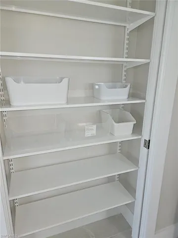 a view of a closet with wooden racks