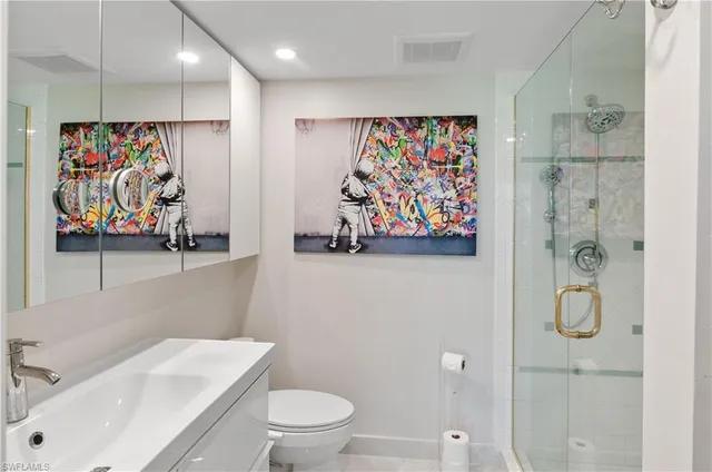 a bathroom with a toilet a sink and a shower curtain