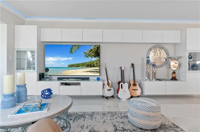 a living room with furniture a rug and white walls