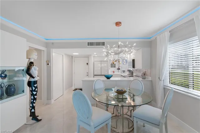 a view of a dining room with furniture and a chandelier