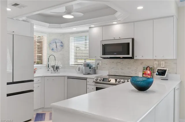 a kitchen with a sink a counter and appliances