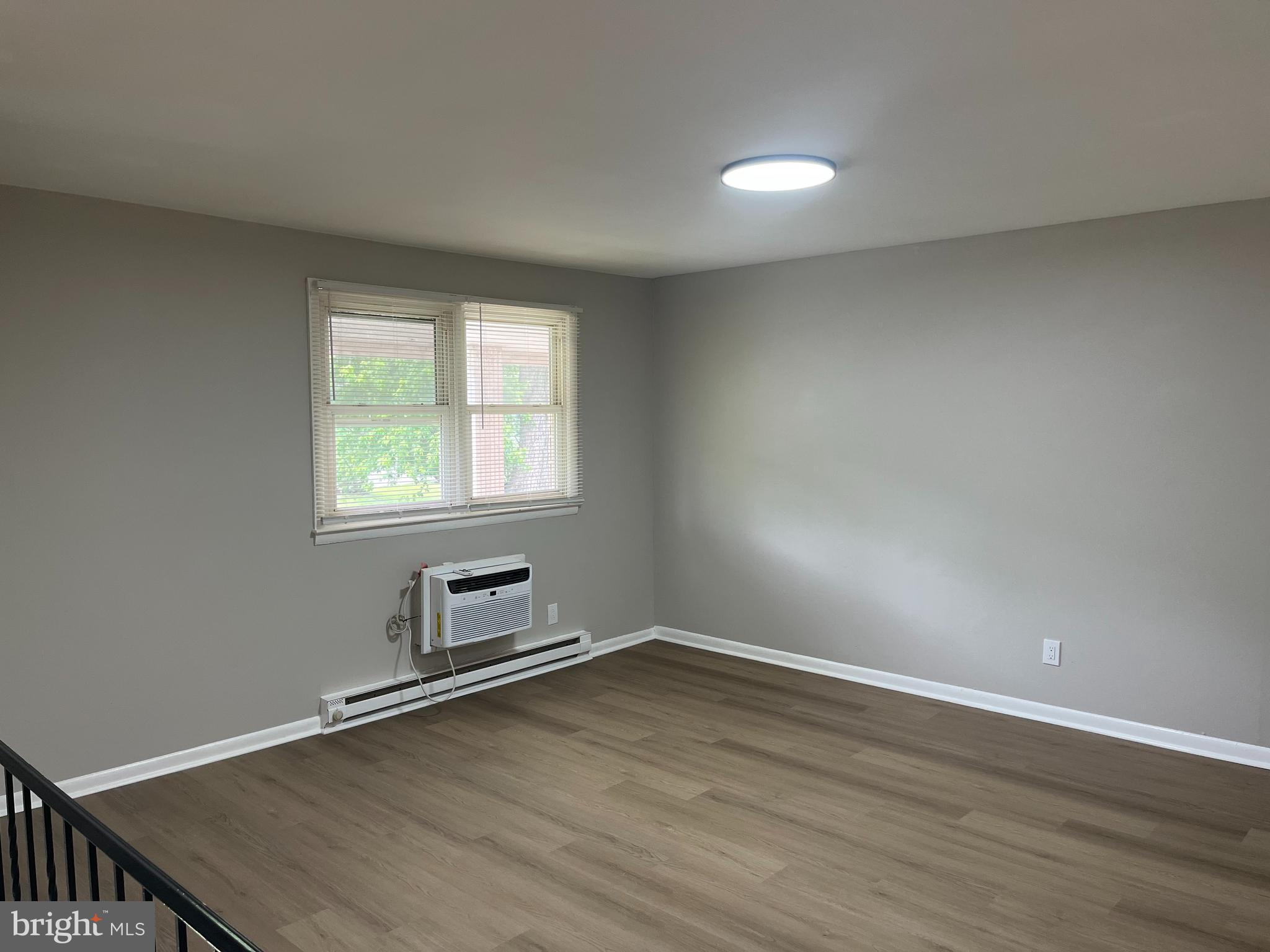 319 Columbia Avenue, Unit 227 Stratford, NJ 08084 - Photo 13 of 13 wooden floor in an empty room with a window