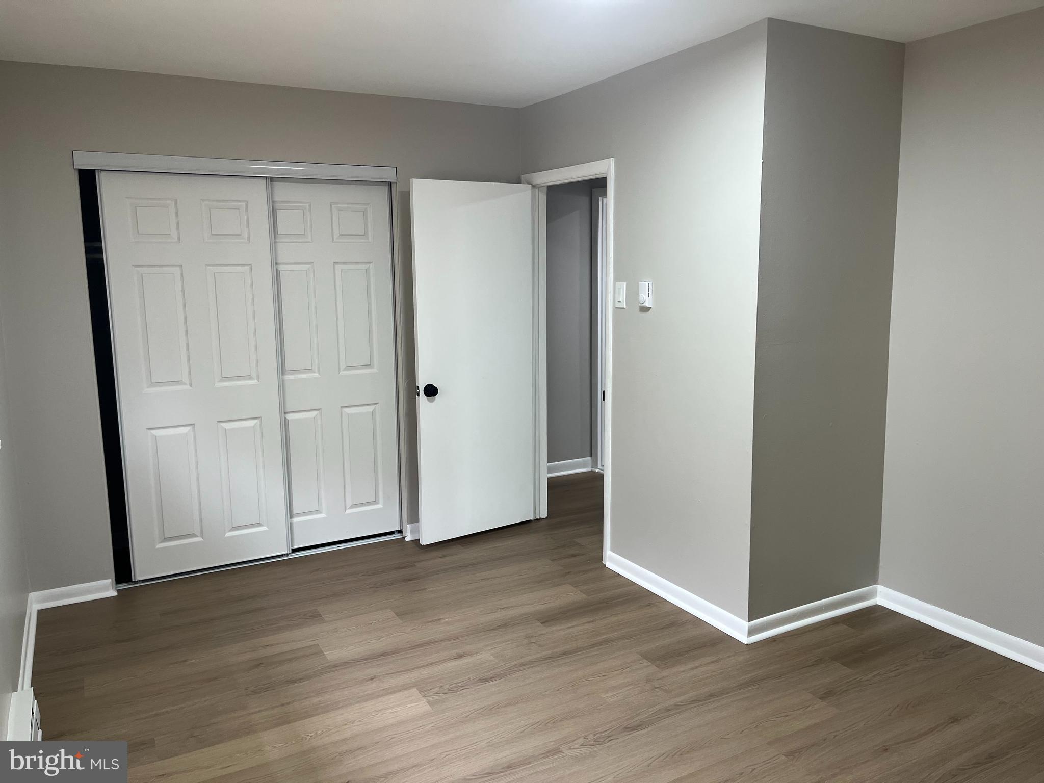 319 Columbia Avenue, Unit 227 Stratford, NJ 08084 - Photo 3 of 13 a view of an empty room with wooden floor and closet