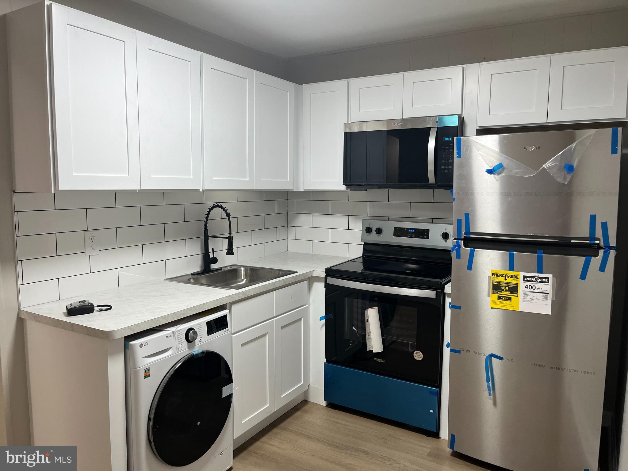 319 Columbia Avenue, Unit 227 Stratford, NJ 08084 - Photo 8 of 13 a kitchen with stainless steel appliances a stove a sink a refrigerator a microwave and cabinets