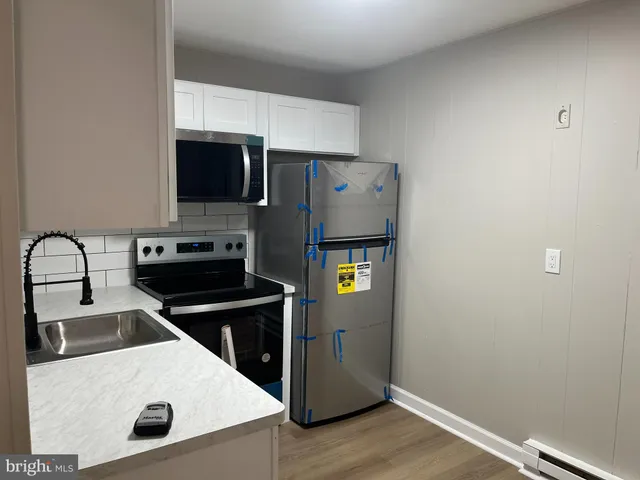 a kitchen with a refrigerator sink and stove