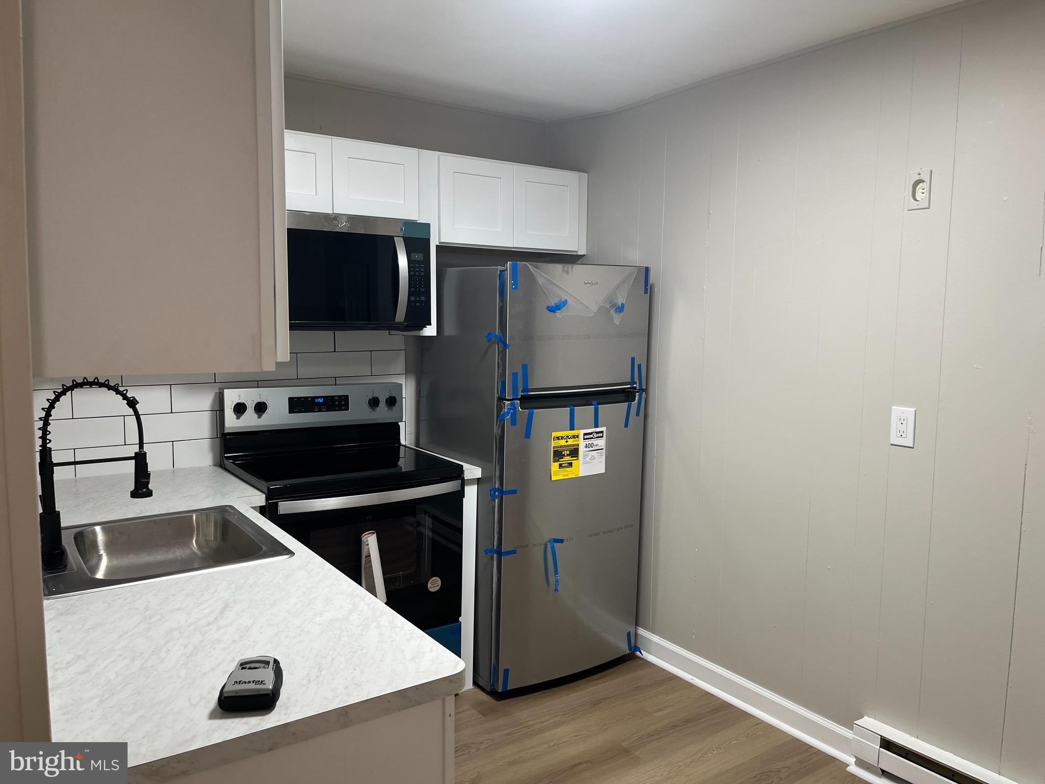319 Columbia Avenue, Unit 227 Stratford, NJ 08084 - Photo 9 of 13 a kitchen with a refrigerator sink and stove