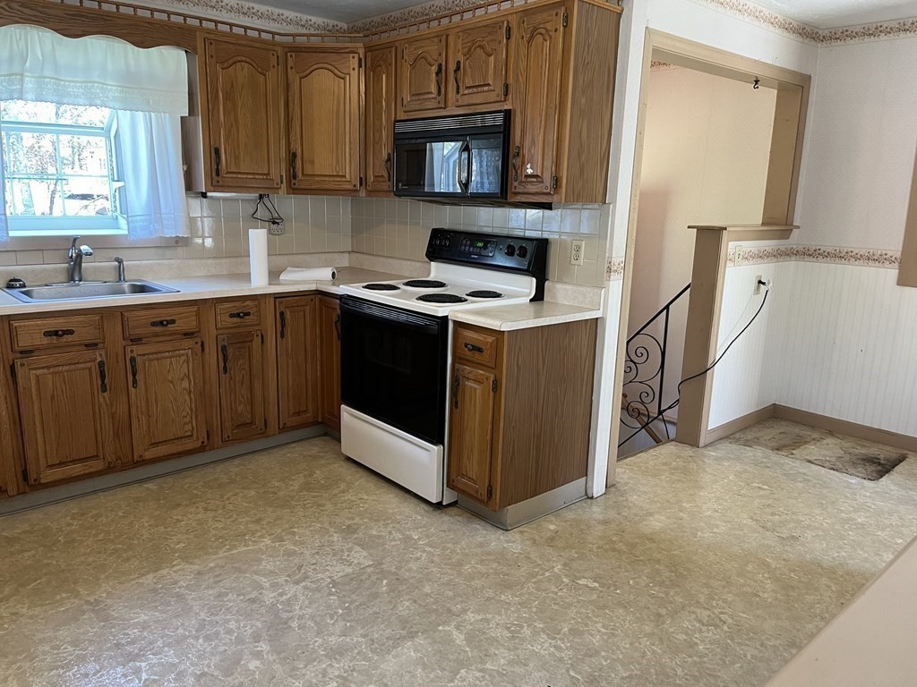 2550 Bay Road Stoughton, MA 02072 - Photo 11 of 20 a kitchen with stainless steel appliances granite countertop a stove a sink and a refrigerator