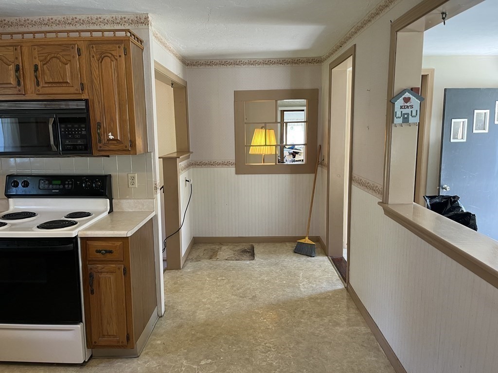 2550 Bay Road Stoughton, MA 02072 - Photo 12 of 20 a view of a kitchen with fridge and wooden floor