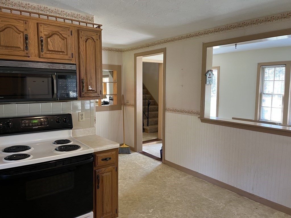 2550 Bay Road Stoughton, MA 02072 - Photo 13 of 20 a kitchen with stainless steel appliances a stove a microwave and a refrigerator