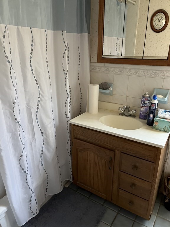 2550 Bay Road Stoughton, MA 02072 - Photo 20 of 20 a bathroom with a sink and a mirror
