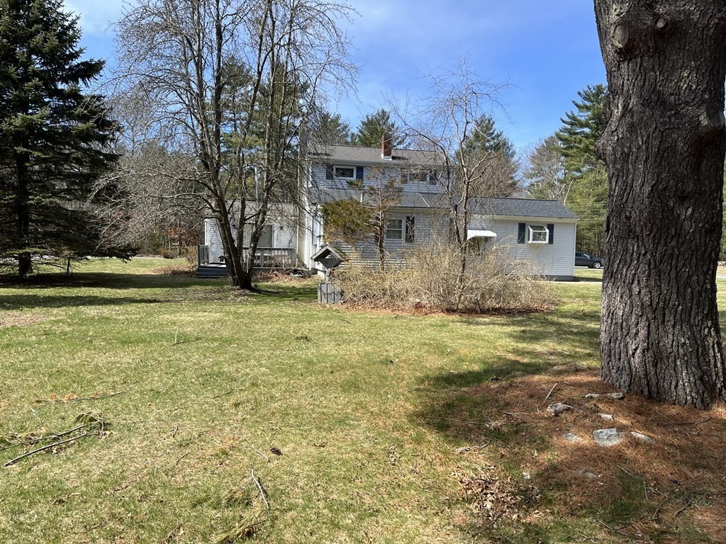 2550 Bay Road Stoughton, MA 02072 - Photo 5 of 20 a view of a yard in front of the house with a large tree