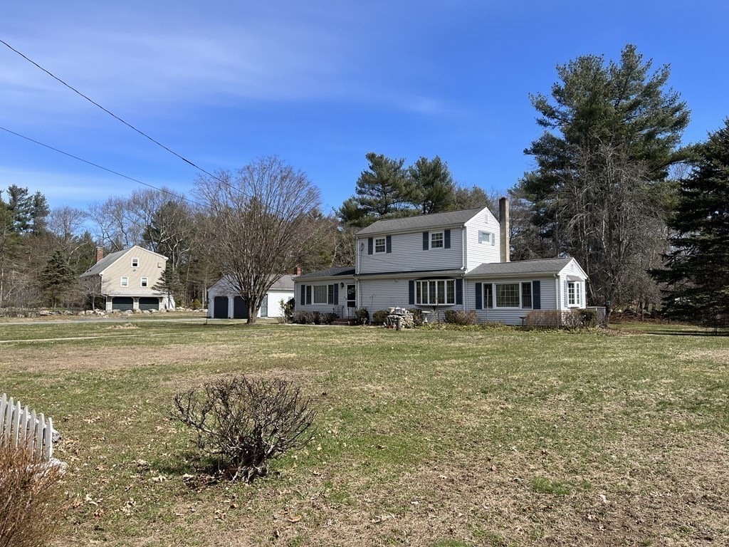 2550 Bay Road Stoughton, MA 02072 - Photo 8 of 20 a front view of a house with a yard and trees