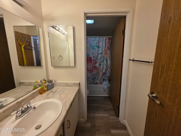a bathroom with a tub sink and mirror
