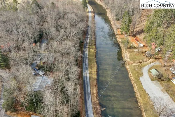 a view of a dry yard with wooden fence