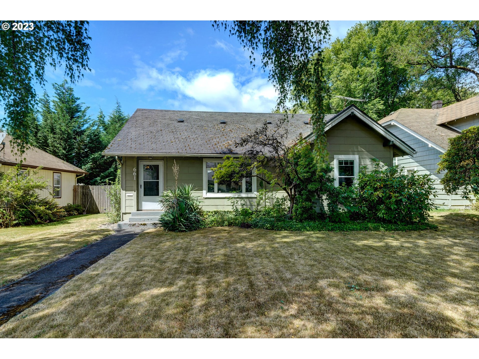 661 18th Avenue Longview, WA 98632 - Photo 2 of 39 a view of a yard in front of a house with large windows
