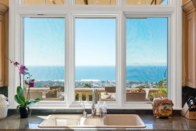 a kitchen with stainless steel appliances granite countertop a kitchen island a stove and a refrigerator