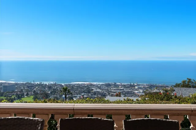 an aerial view of residential building and ocean view