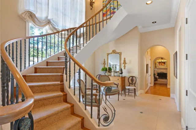 a spacious bedroom with a bed and glass windows