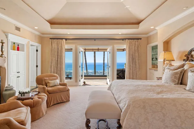 a spacious bedroom with a bed and potted plant