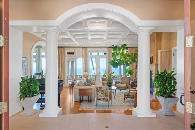a living room with furniture and a potted plant