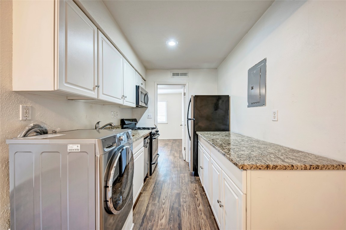 1106 West 22nd Street, Unit 4 Austin, TX 78705 - Photo 11 of 12 a kitchen with stainless steel appliances granite countertop a refrigerator a stove and a sink
