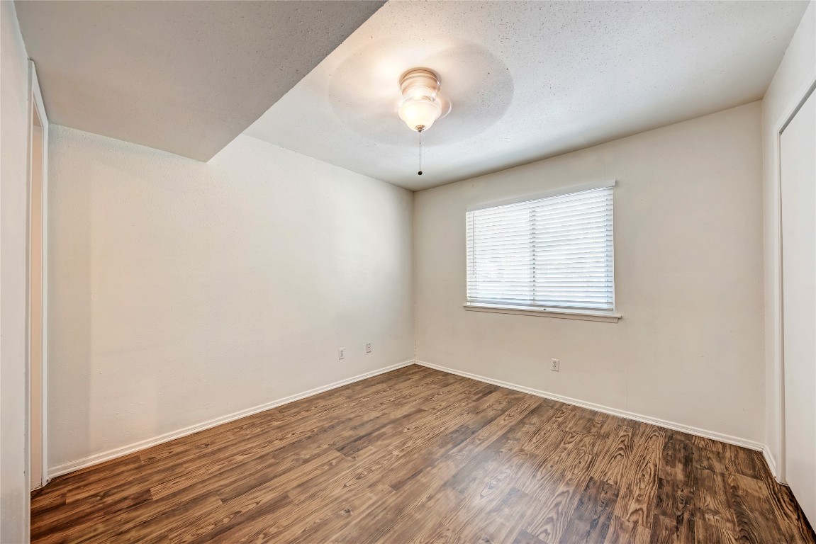 1106 West 22nd Street, Unit 4 Austin, TX 78705 - Photo 12 of 12 an empty room with wooden floor and windows